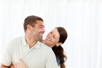 Obraz premium Lovely couple laughing together in the living room