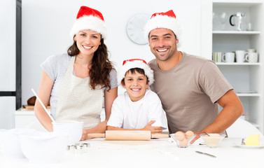 Portrait of a happy family preparing christmas cookies