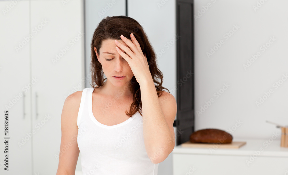 Wall mural exhausted woman having a headache in her bathroom