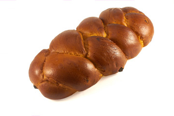 braided golden loaf is isolated on a white background