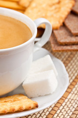 Breakfast: a cup of  coffee with a lump sugar and crackers
