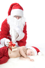 Santa is giving gift to sleeping baby