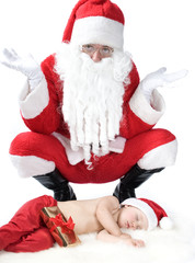 Santa is giving gift to sleeping baby
