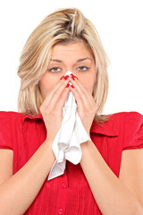Infected woman blowing her nose in tissue paper because of being
