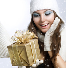 Beautiful Happy Girl with Christmas Gift. Snow