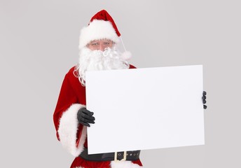 Santa holding blank white board