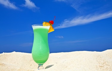 Fruity cocktail is on a beach