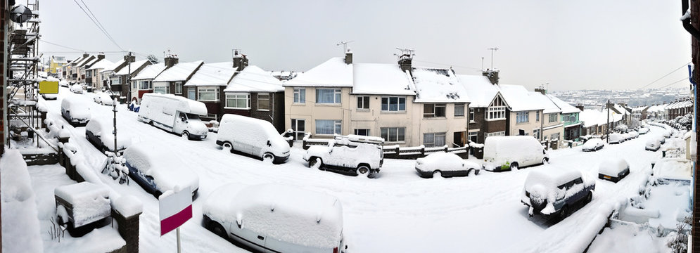 Typical english street covered by snow in winter