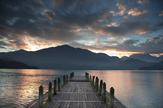 Fototapeta Sunrise over mountain and Looking over a pier