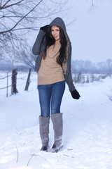 Fototapeta na wymiar Beautiful and sexy woman in snowy winter outdoors