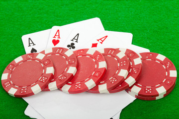 winning poker hand of four aces playing cards and chips