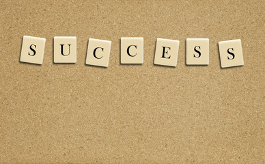 success word on cork board background