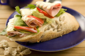 sandwich with ham, salad and tomato