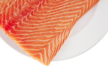 fresh uncooked salmon fillet on white plate