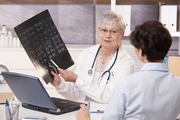 Doctor showing x-ray results to patient