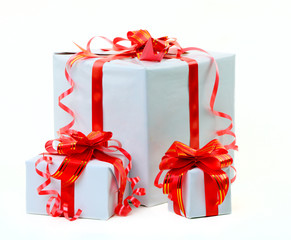 A white box tied with a red satin ribbon bow. A gift for Christm