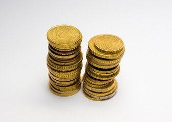 Two piles of euro coins isolated on white