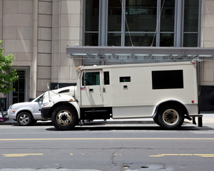 Side View Armoured Armored Car Parked on Street Outside Building - 28183079