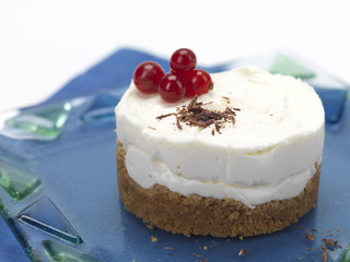 cheese cake with cranberries in a glass plate