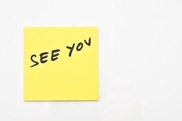 Yellow square Post it with  See you written on it