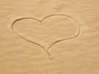 Fototapeta na wymiar Heart in the Sand on a Sunny Day
