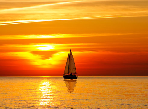 Fototapeta Sailing at sunset