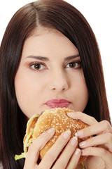 Beautiful caucasian woman eating hamburger