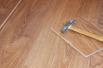 hammer and laminate plank on floor