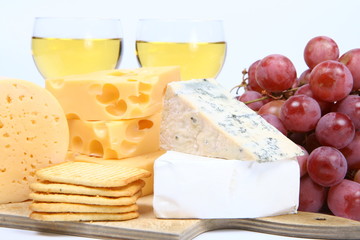 Various types of cheese and white wine