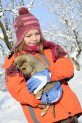 cheerful girl playing with baby dog