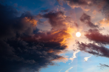 Dramatic sunset clouds surrounding sun. - 28204662