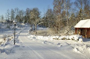 Idyllic winter road to Swedish farm