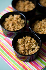 Home made apple crumble in black containers