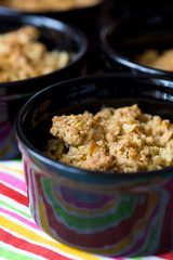 Home made apple crumble in black containers