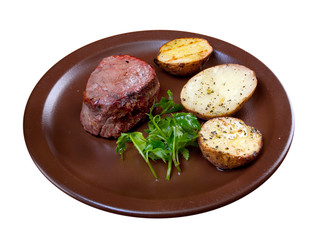 Grilled beef on white plate with potatoes