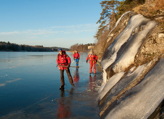 Three scandinavian skaters on a frozen lake