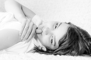 Woman white portret.  Fingers on lips. grayscale.