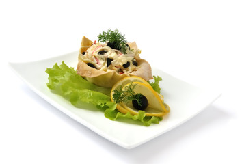 Salad with crab meat in a basket