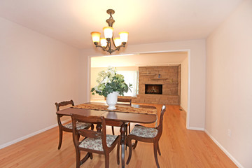 Dining room with table and fireplace, empty