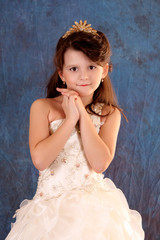 Fototapeta na wymiar Little girl in white dress on blue background