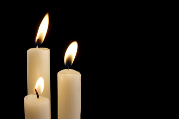 Three canldles isolated on black background