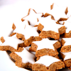 Plate of christmas star shaped cookies with white icing