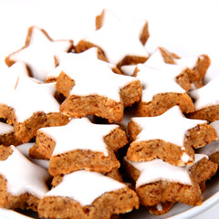 Plate of christmas star shaped cookies with white icing
