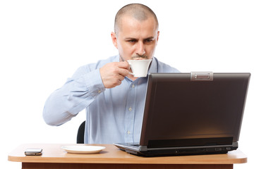 Young businessman with coffee and laptop