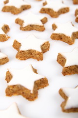 Christmas star shaped cookies with white icing on white