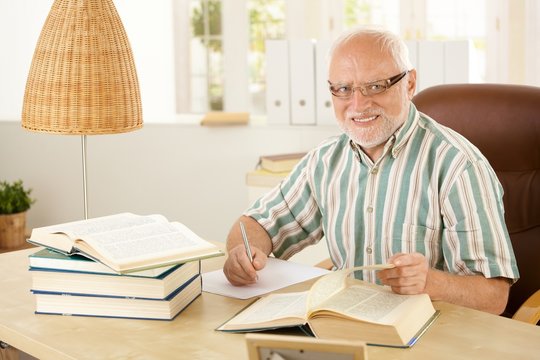 Elderly professor working in his study