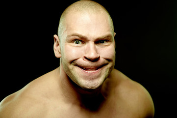 Emotional portrait of muscular aggressive man