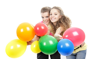 Fototapeta na wymiar two young happy girls with balloons over white