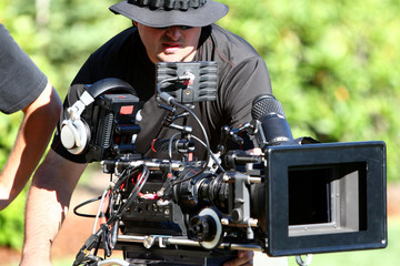 Man with digital cinema camera on movie set