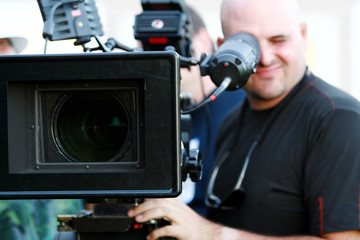 Man with digital cinema camera on movie set